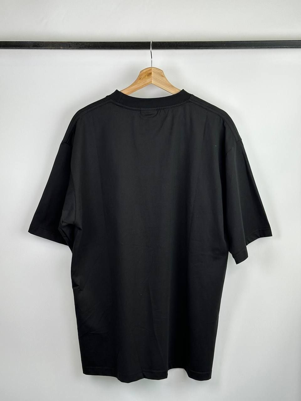 Black T-shirt with blurred logo, L