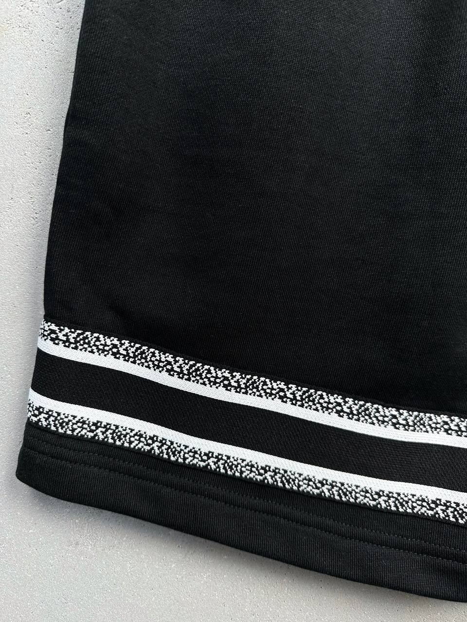 Black shorts with white stripes at the bottom, L