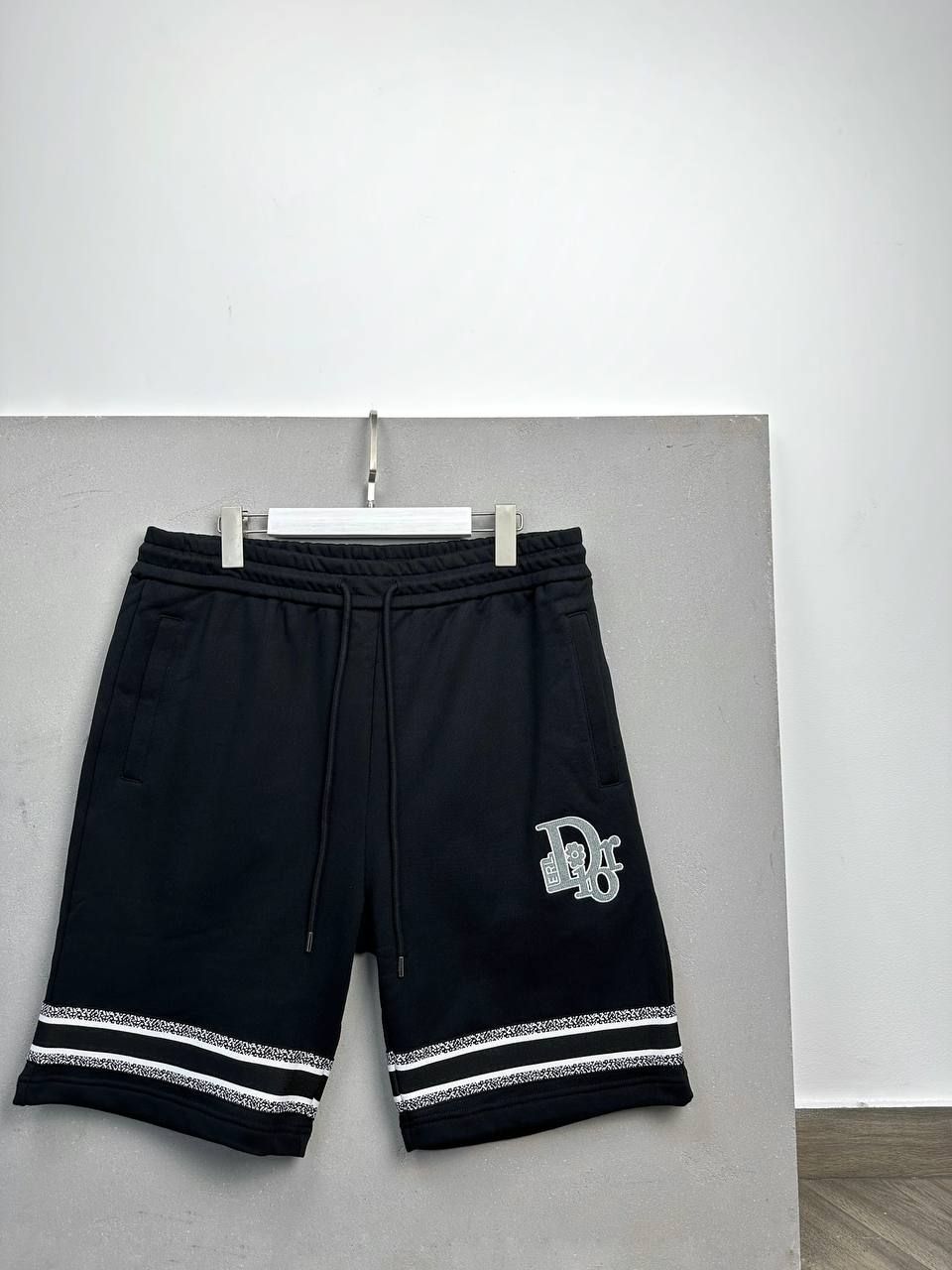 Black shorts with white stripes at the bottom, L