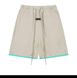 Beige shorts with a green rim at the bottom, S