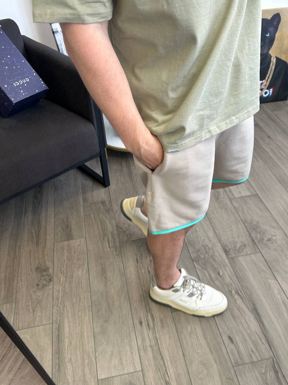 Beige shorts with a green rim at the bottom, L