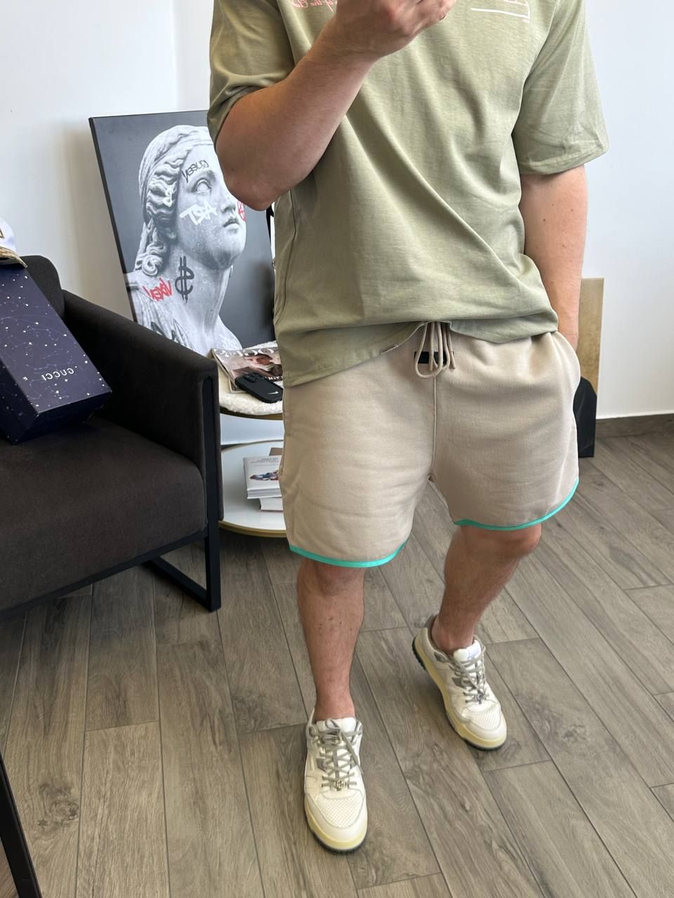 Beige shorts with a green rim at the bottom, S