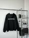 Black hoodie with a small inscription on the front, S